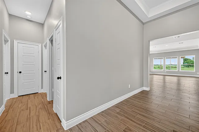 a view of hallway with wooden floor