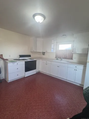 a large kitchen with cabinets and stainless steel appliances