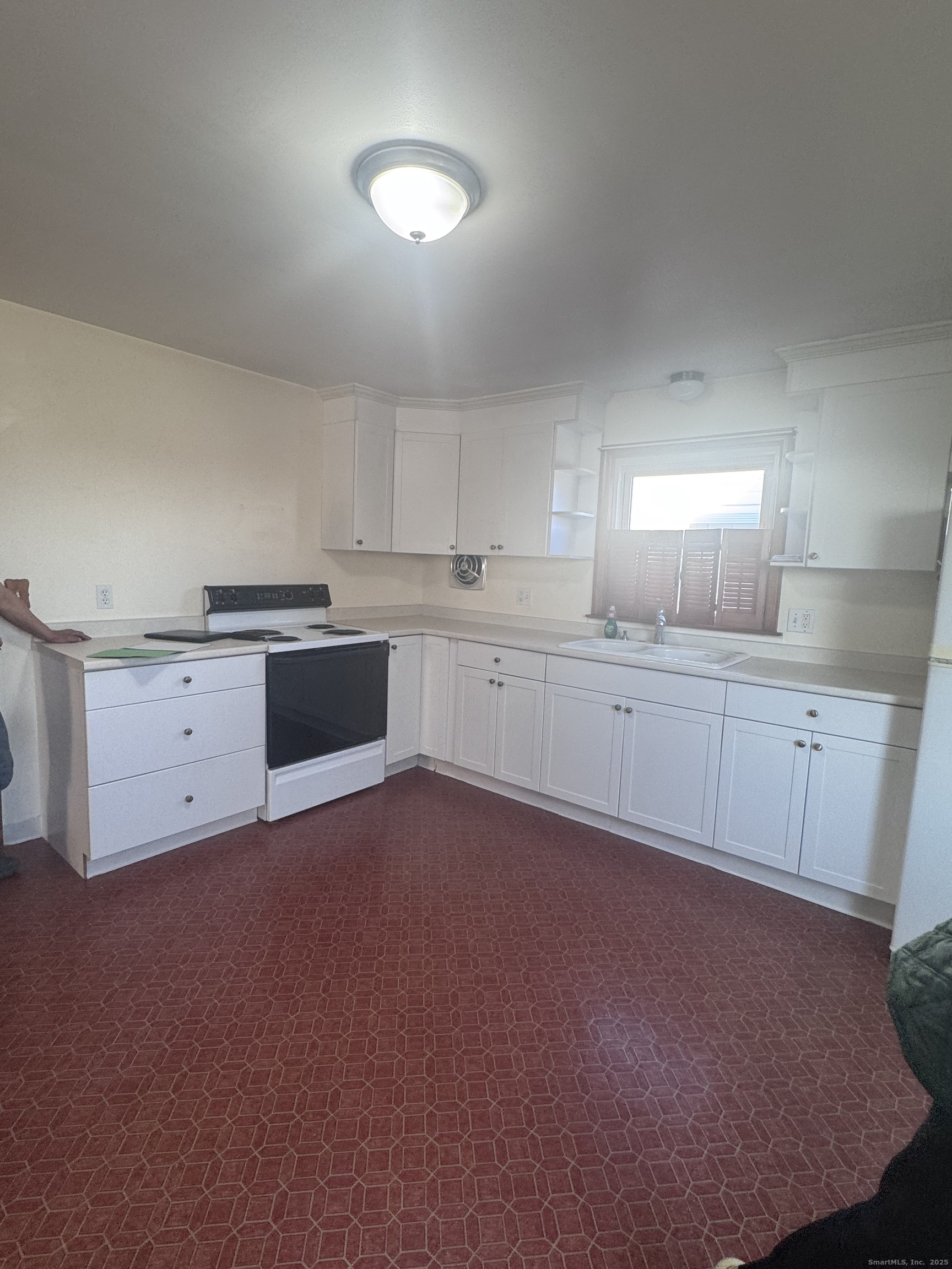 212 Dayton Road Bridgeport, CT 06606 - Photo 2 of 14 a large kitchen with cabinets and stainless steel appliances