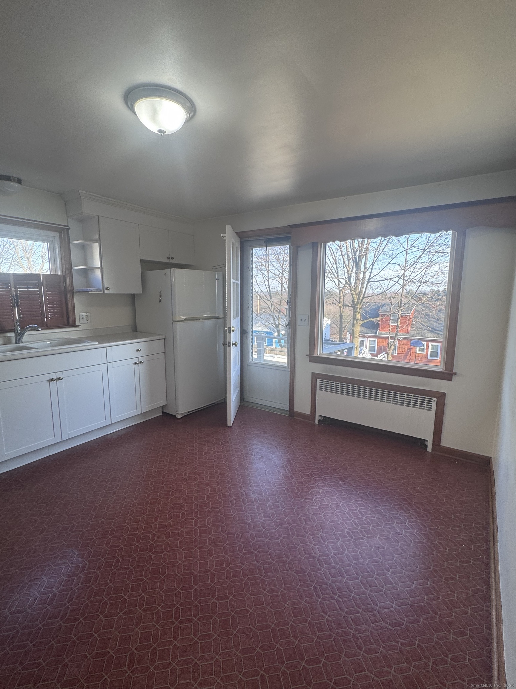212 Dayton Road Bridgeport, CT 06606 - Photo 3 of 14 a view of a kitchen with refrigerator and window