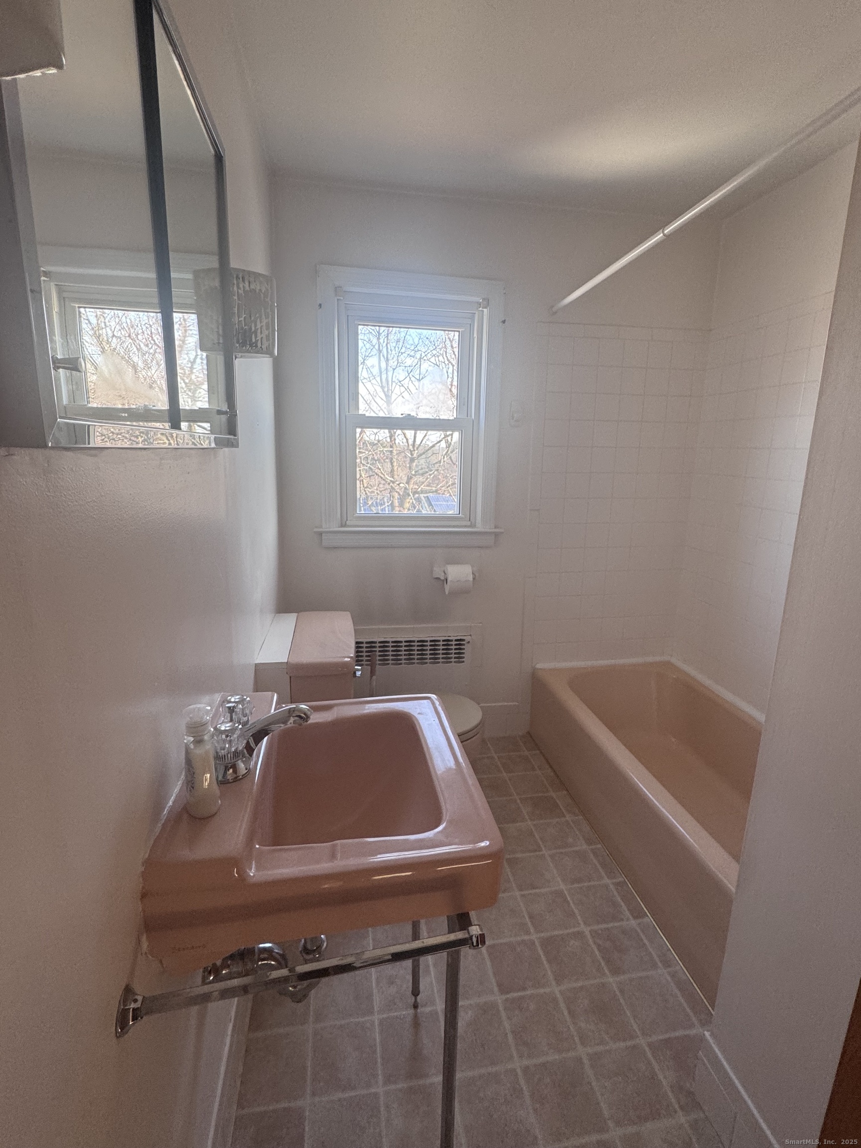 212 Dayton Road Bridgeport, CT 06606 - Photo 7 of 14 a bathroom with a tub sink and mirror