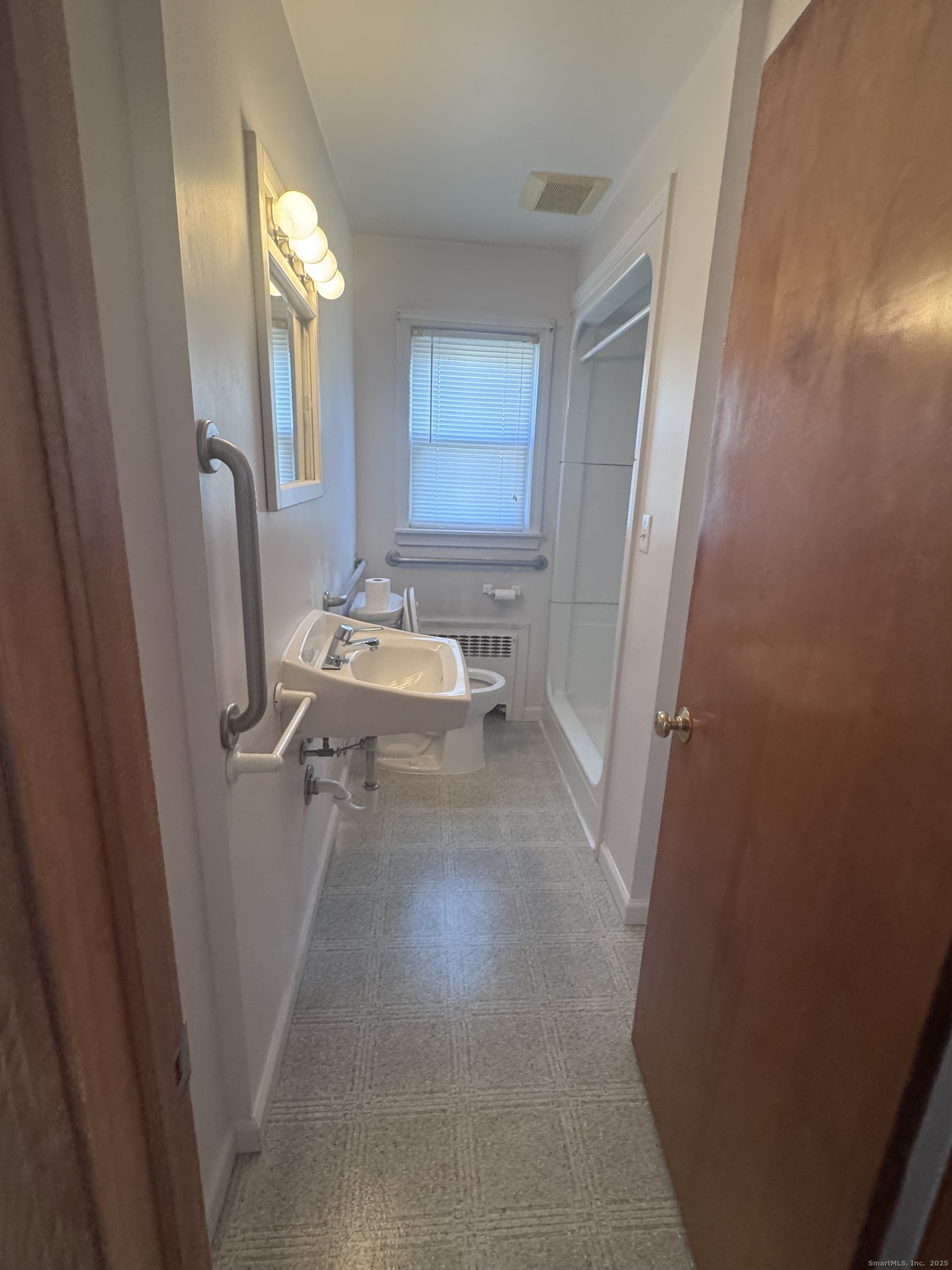 212 Dayton Road Bridgeport, CT 06606 - Photo 10 of 14 a bathroom with sink and mirror