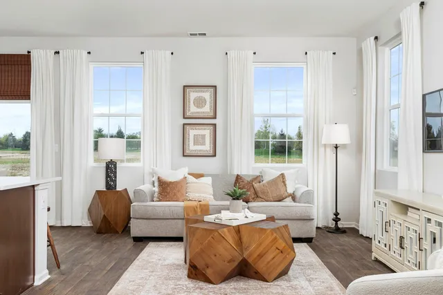 a living room with furniture and a large window