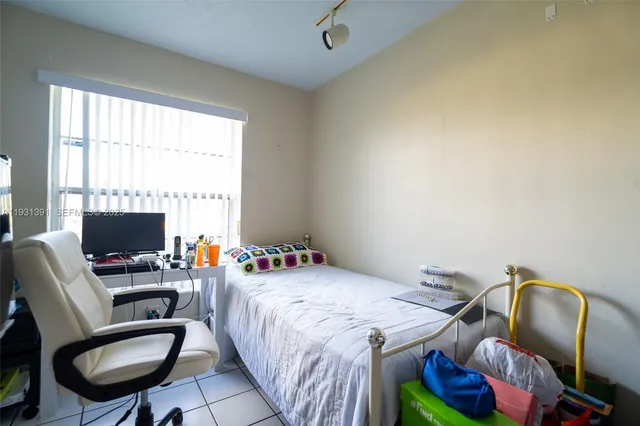 a bedroom with a bed and a chair