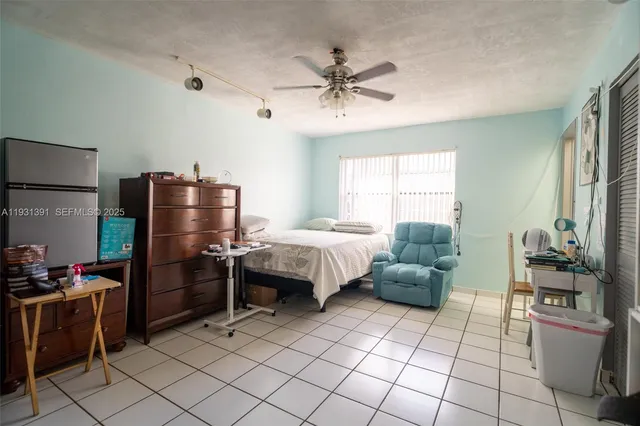 a bedroom with furniture and a window