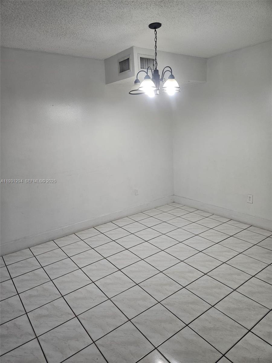 7211 West 24th Avenue, Unit 2304 Hialeah, FL 33016 - Photo 26 of 35 a view of room with chandelier
