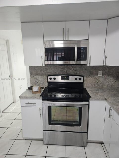 7211 West 24th Avenue, Unit 2304 Hialeah, FL 33016 - Photo 5 of 35 a stove top oven sitting inside of a kitchen