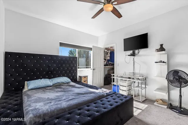 a bedroom with a bed and flat screen tv