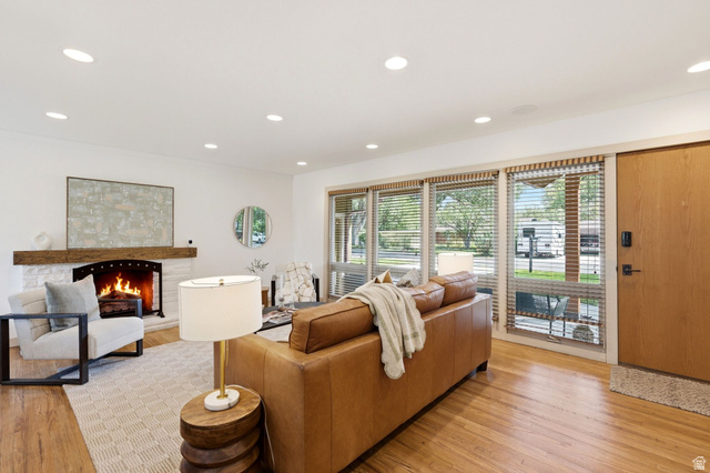 1709 Meadowmoor Road Holladay, UT 84117 - Photo 6 of 32 Wood-finish flooring, recessed lighting, and a stone-clad fireplace with a wood mantel