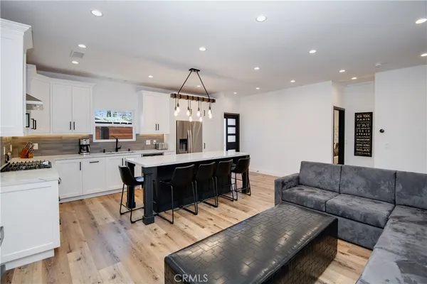 a living room with furniture and kitchen view