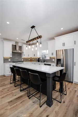 a kitchen with a table chairs sink and cabinets