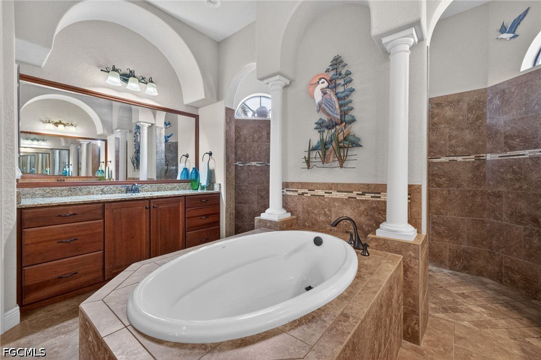 6109 Calusa Rdg Trail Bokeelia, FL 33922 - Photo 29 of 48 a bathroom with a tub sink and mirror