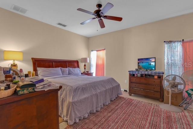 5120 Shale Ridge Trail Orlando, FL 32818 - Photo 9 of 15 a bedroom with a bed and a chandelier