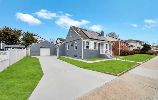 a front view of house with yard and green space