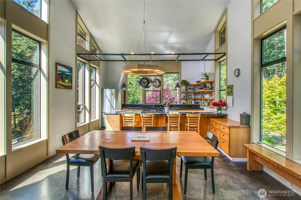 a dining room with furniture a chandelier and wooden floor