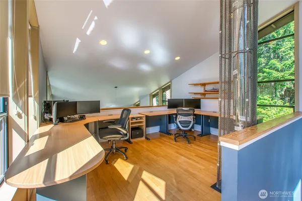 a view of a workspace with furniture and a fireplace