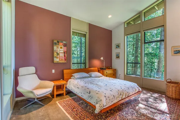 a bedroom with a bed a table and chair