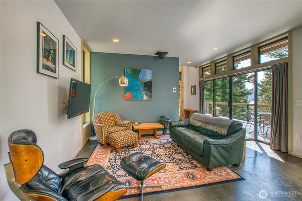 a living room with furniture and a floor to ceiling window