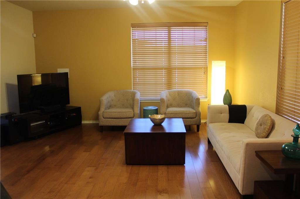 1310 West Parmer Lane, Unit 1503 Austin, TX 78727 - Photo 14 of 26 Living room with dark wood-style flooring and baseboards