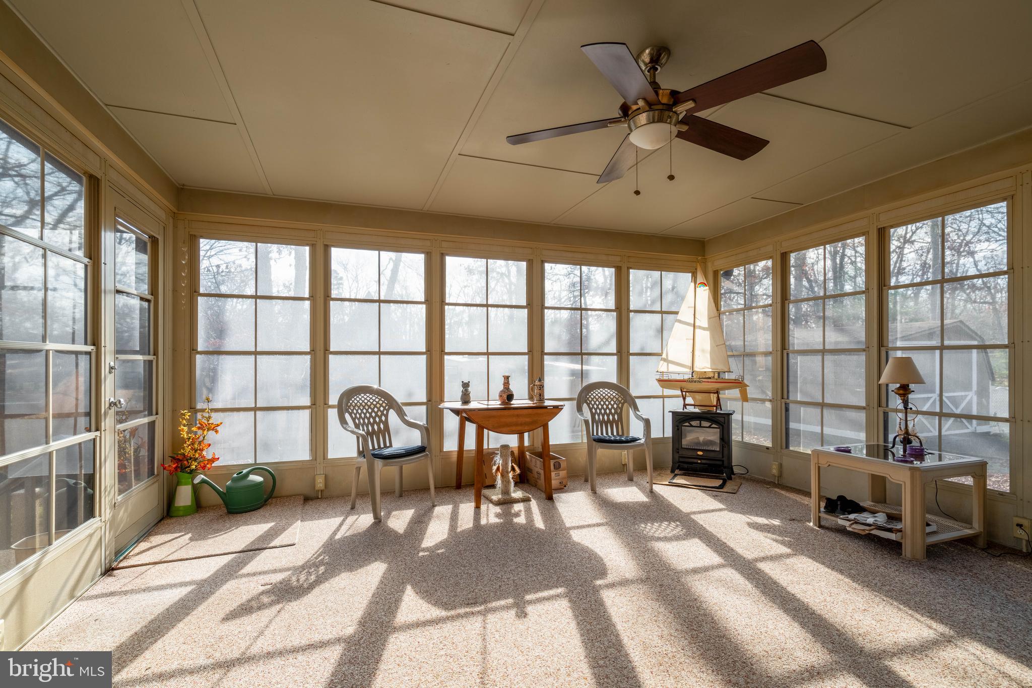 701 Uranus Road Millville, NJ 08332 - Photo 19 of 29 a living room with furniture floor to ceiling windows and a table
