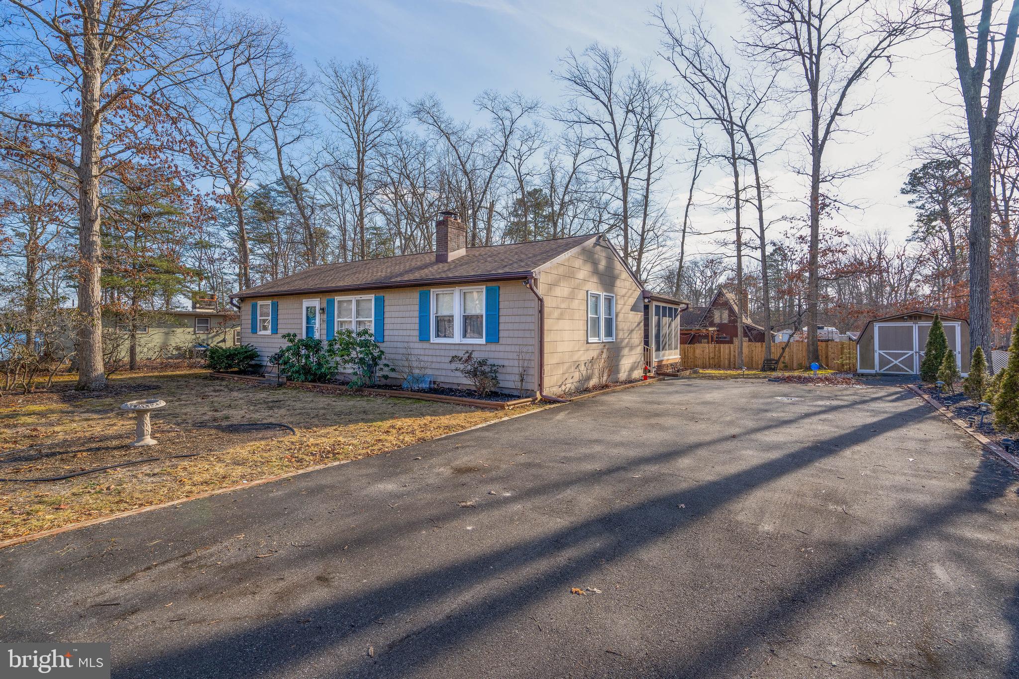 701 Uranus Road Millville, NJ 08332 - Photo 3 of 29 a front view of a house with a yard and garage