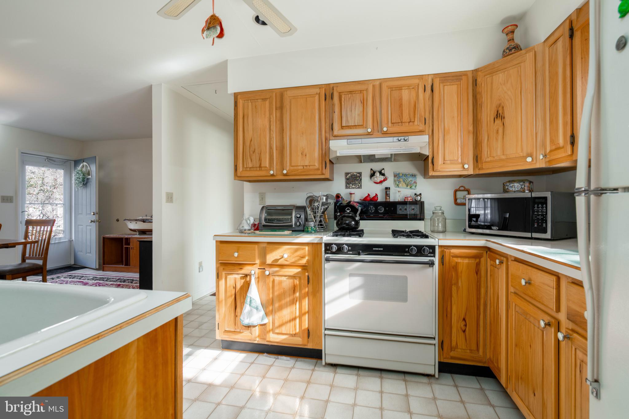 701 Uranus Road Millville, NJ 08332 - Photo 7 of 29 a kitchen with stainless steel appliances granite countertop a stove sink and cabinets