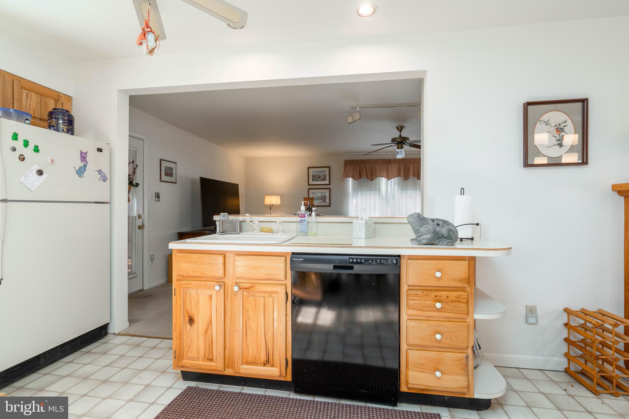 701 Uranus Road Millville, NJ 08332 - Photo 8 of 29 a kitchen with stainless steel appliances granite countertop a refrigerator a sink and white cabinets