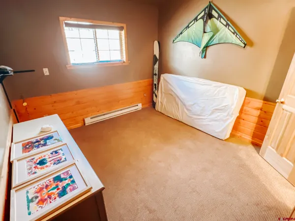 wooden floor with a ceiling fan and a window
