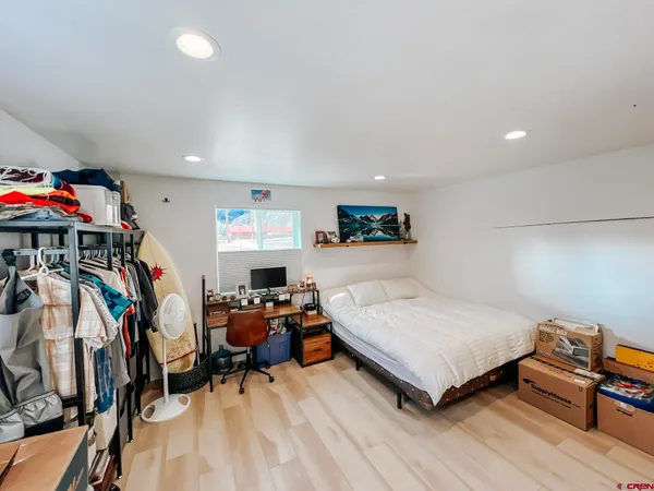 a bed room with two bed and a large mirror