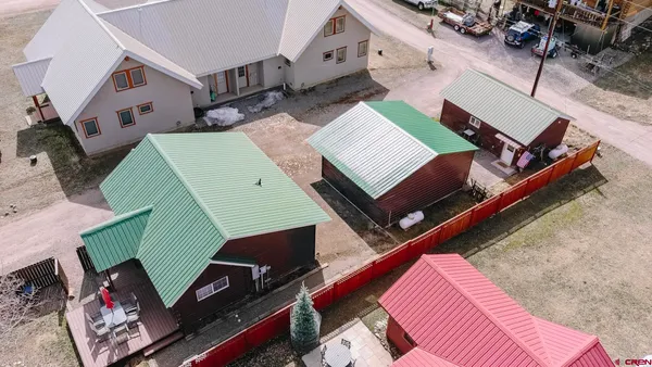 a front view of a house with a yard covered in snow