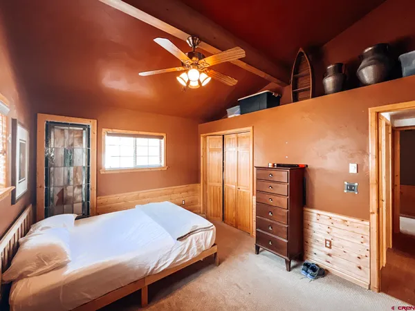 a bed sitting in a bedroom next to a window