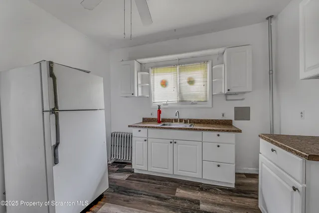a kitchen with stainless steel appliances a refrigerator and a sink