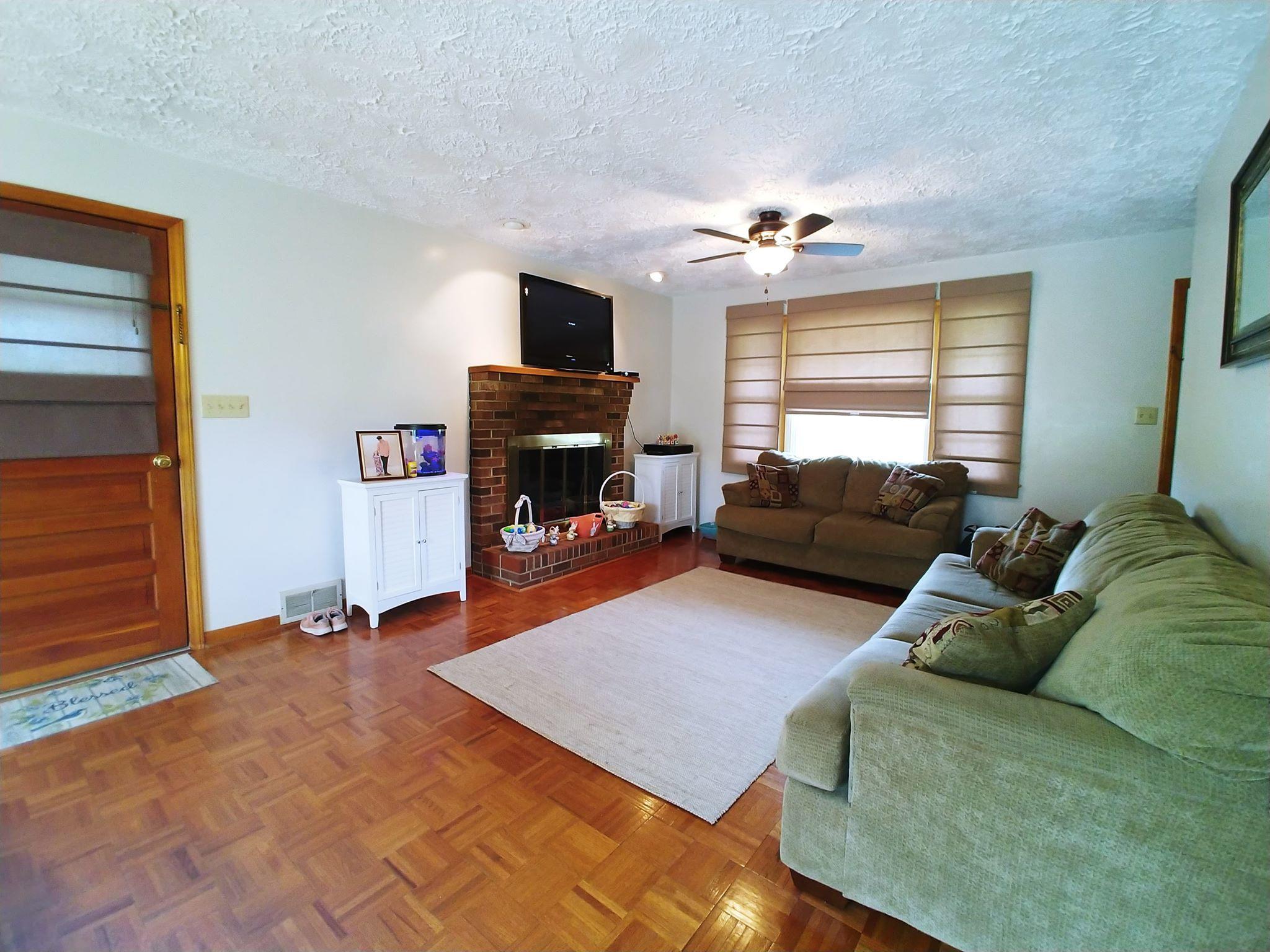 461 Old Forge Road Callaway, VA 24067 - Photo 7 of 29 a living room with furniture a fireplace and a flat screen tv