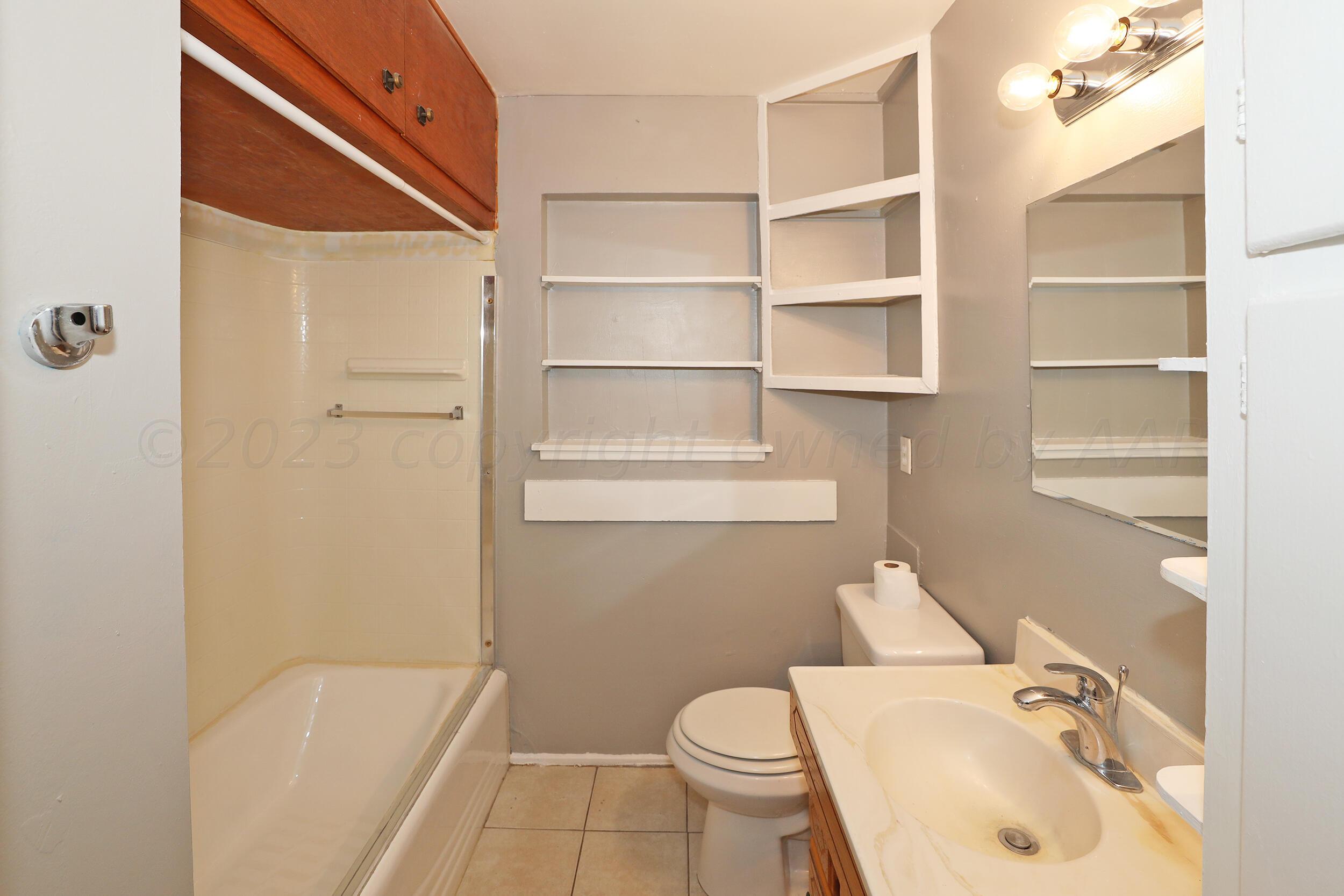 3820 Beaver Drive Amarillo, TX 79107 - Photo 14 of 25 a bathroom with a sink a toilet and shower