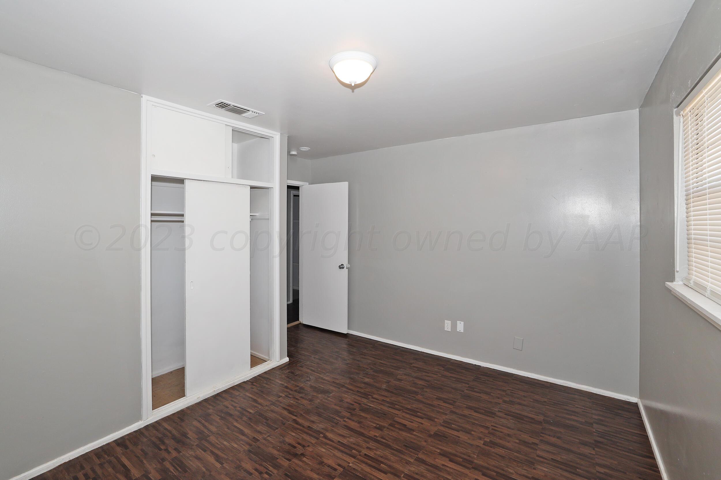 3820 Beaver Drive Amarillo, TX 79107 - Photo 16 of 25 a view of an empty room with wooden floor and a window