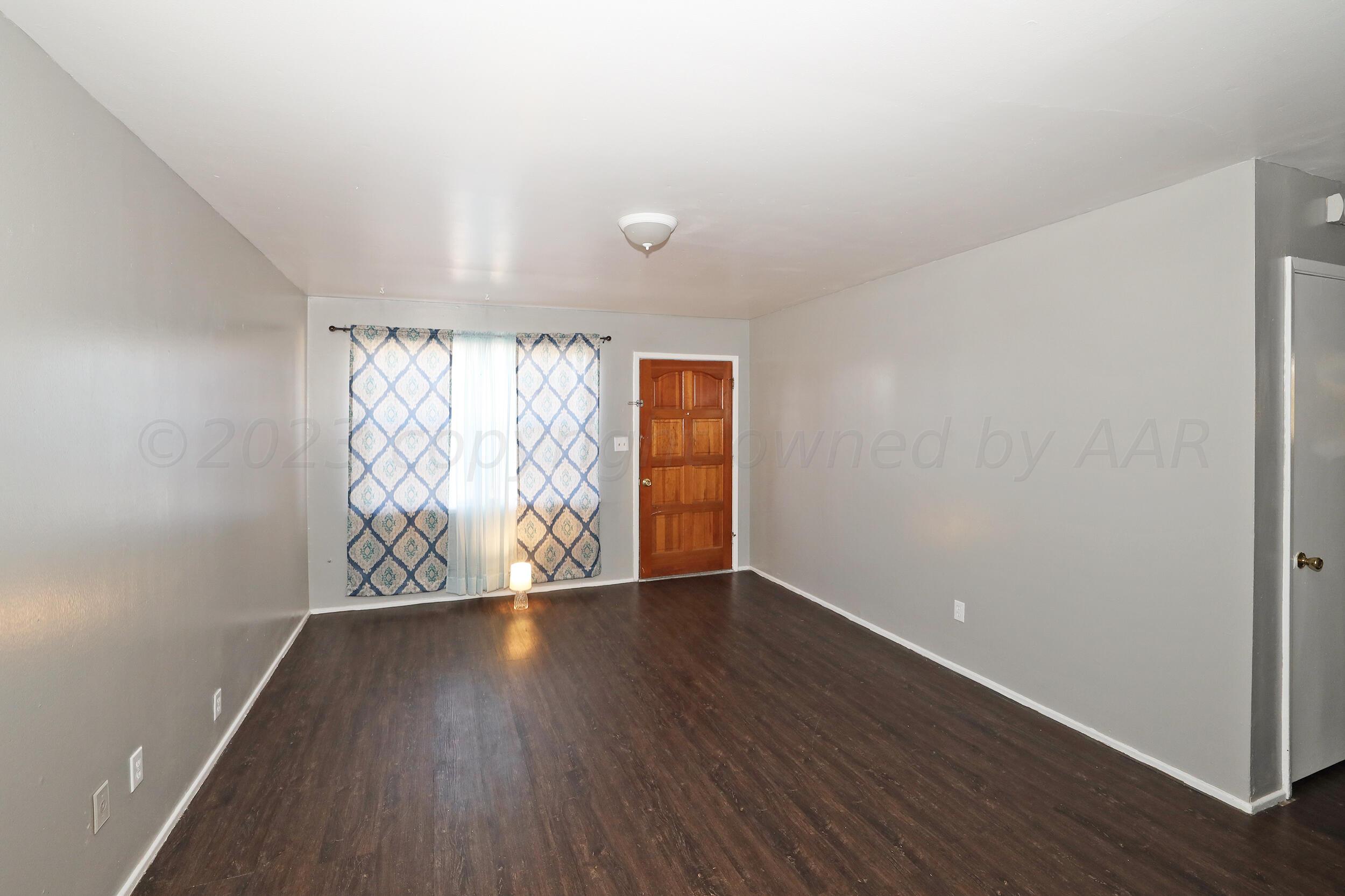3820 Beaver Drive Amarillo, TX 79107 - Photo 19 of 25 a view of an empty room with wooden floor and a window