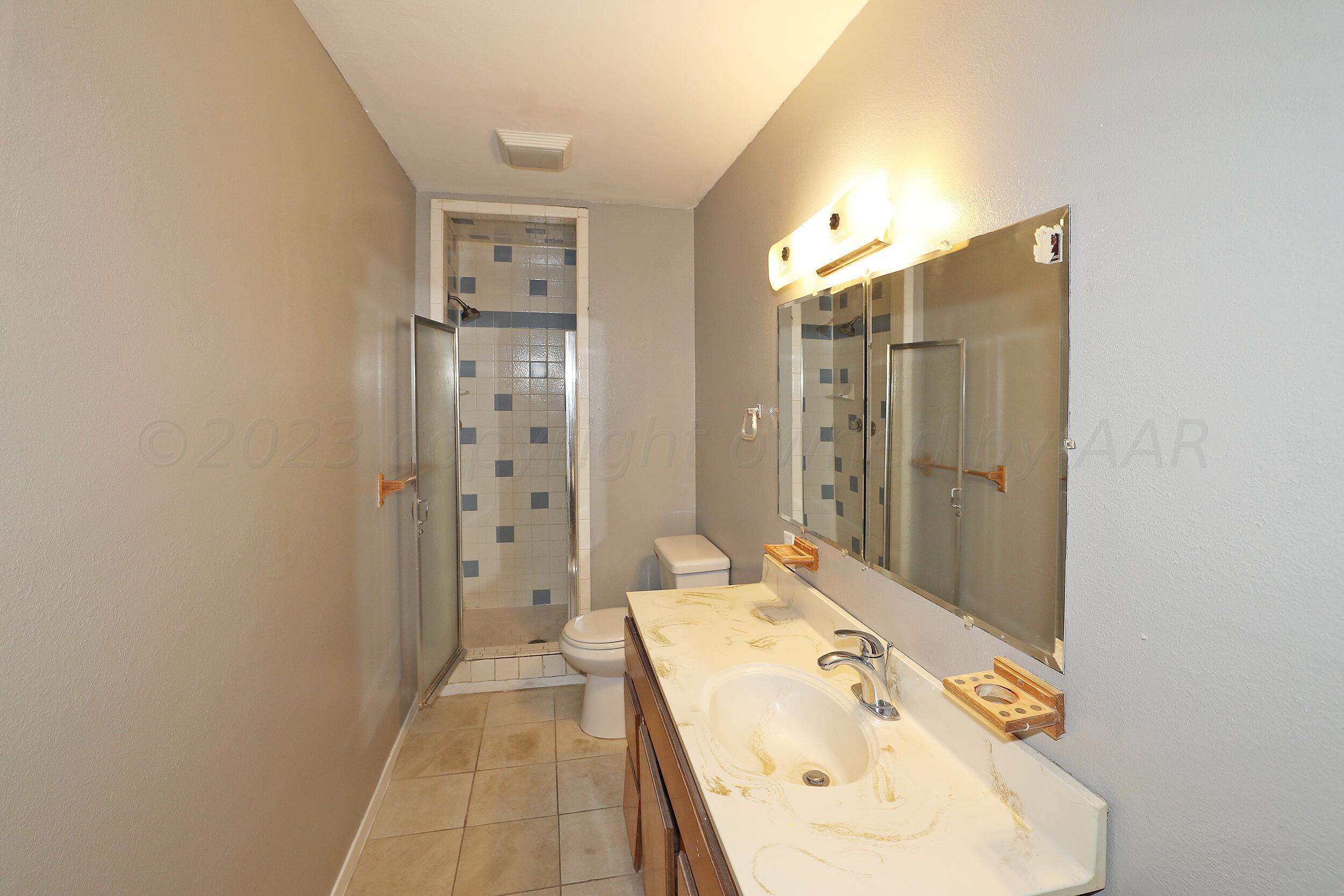 3820 Beaver Drive Amarillo, TX 79107 - Photo 9 of 25 a bathroom with a bathtub and shower