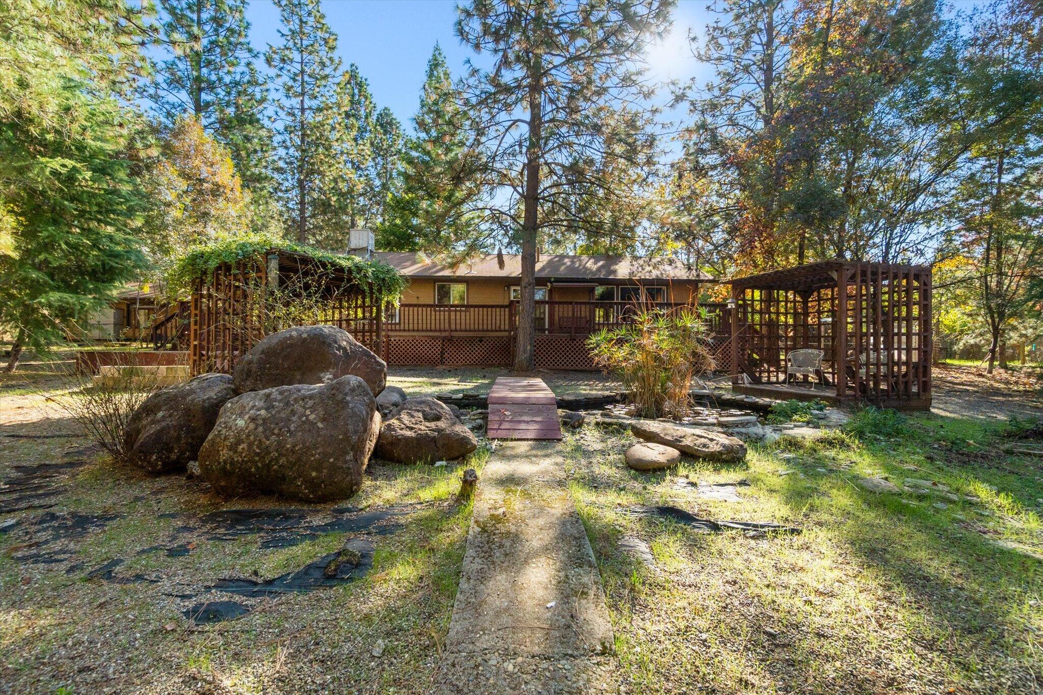 28449 Whippoorwill Circle Shingletown, CA 96088 - Photo 34 of 47 a view of a small house with backyard and sitting area