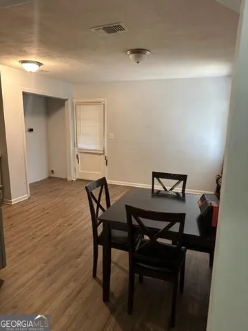 a view of a room with furniture and wooden floor