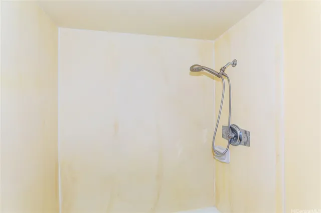 a view of a street with a building and a palm tree