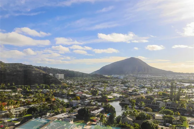 a living room with furniture a chandelier and large window