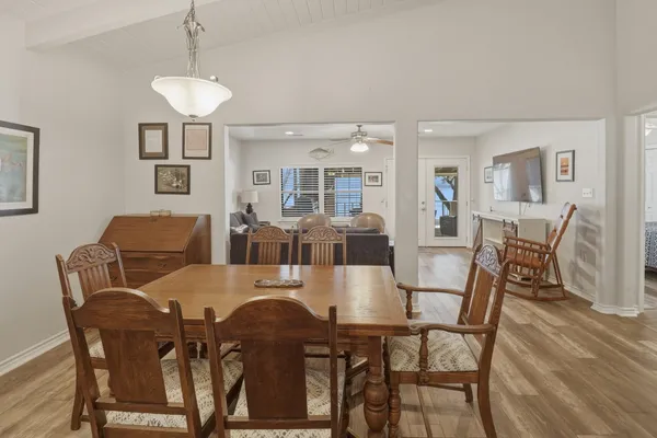 a view of a dining room with furniture and chandelier