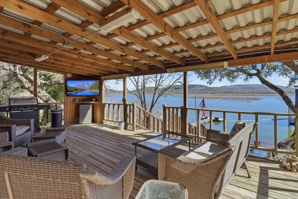 a view of a patio with couches chairs and wooden floor