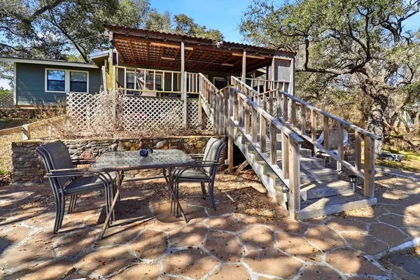 a view of a house with backyard and sitting area