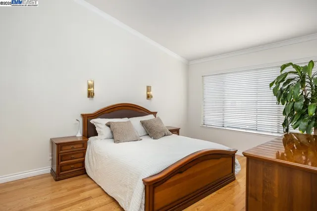 a bedroom with a bed and a potted plant