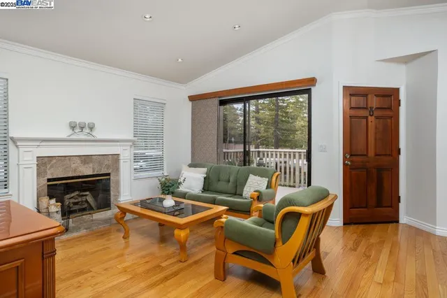a living room with furniture a fireplace and a table