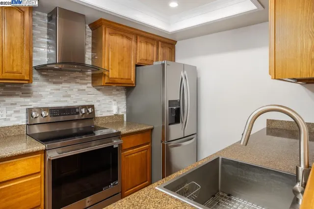 a kitchen with a stove a sink and a refrigerator