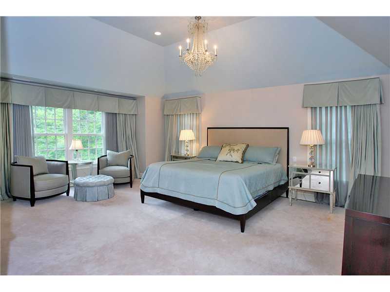 46 Stony Brook Road Darien, CT 06820 - Photo 14 of 24 a bedroom with a bed and a chandelier