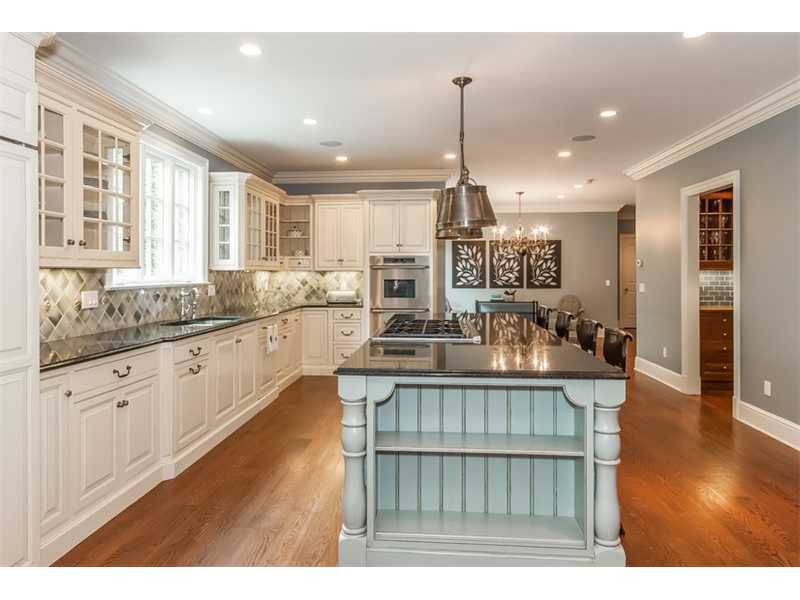 46 Stony Brook Road Darien, CT 06820 - Photo 9 of 24 a open kitchen with kitchen island granite countertop a stove a sink and white cabinets with wooden floor