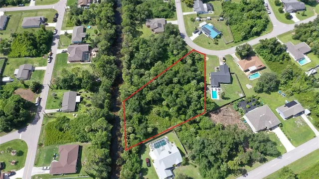 an aerial view of residential house with outdoor space and swimming pool